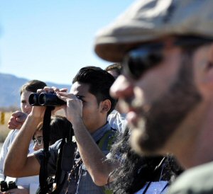 Biologist and students viewing birds